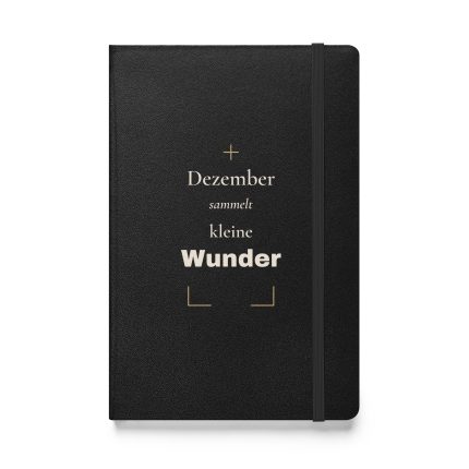 Schwarzes Hardcover-Notizbuch „Dezember sammelt kleine Wunder“ mit cremefarbener Schrift und goldfarbenen Winkeln – Vorderansicht