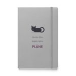 Silbernes Notizbuch mit schlafender Katze und dem Spruch „Zwischen Pfoten liegen meine Pläne“, schräge Ansicht