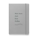 Silbernes Hardcover-Notizbuch „Mein Atem findet freie Zeilen“ mit dunkelgrüner Schrift und kupferbraunen Linien – Vorderansicht