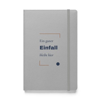 Silbernes Hardcover-Notizbuch „Ein guter Einfall bleibt hier“ mit dunkelblauer Typografie und kupferbraunen Winkeln – Vorderansicht