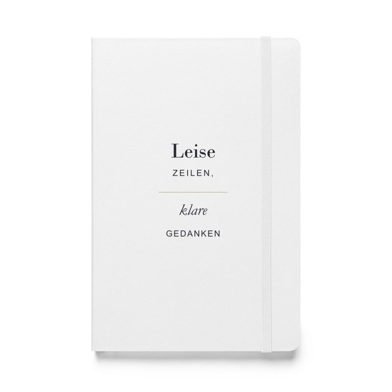 Weißes Hardcover-Notizbuch „Leise Zeilen, klare Gedanken“ mit dunkler Typografie und goldfarbener Linie, Vorderansicht.