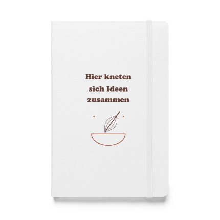 Weißes Hardcover-Notizbuch „Hier kneten sich Ideen zusammen“ mit brauner Schrift und Rührschüssel