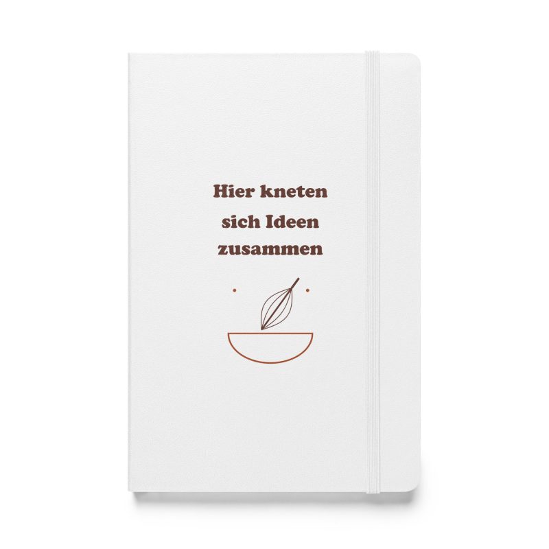 Weißes Hardcover-Notizbuch „Hier kneten sich Ideen zusammen“ mit brauner Schrift und Rührschüssel