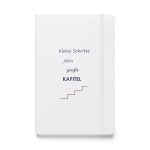 Weißes Hardcover-Notizbuch „Kleine Schritte füllen große Kapitel“, Vorderseite