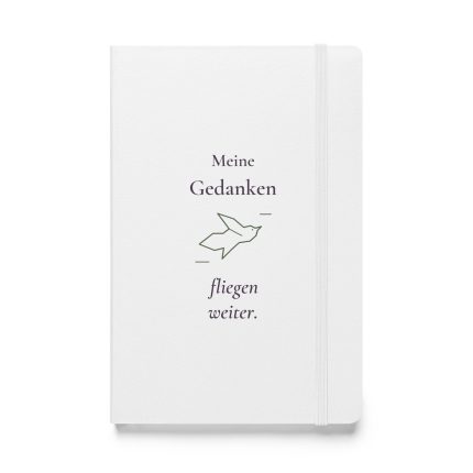 Weißes Notizbuch mit pflaumenfarbener Schrift „Meine Gedanken fliegen weiter.“ und olivgrünem Vogelmotiv, Vorderansicht.